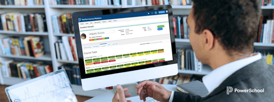 Teacher looking at a computer screen with student test scores