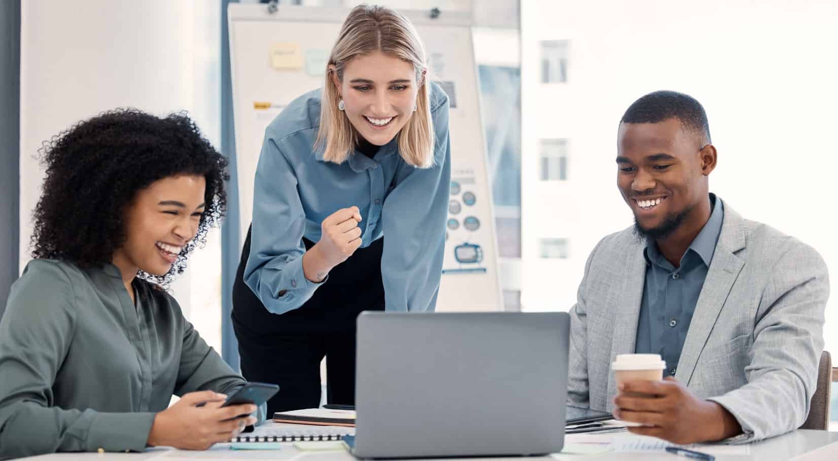 The image depicts a man and two women looking at teacher evaluations from a more comprehensive and data-driven approach.